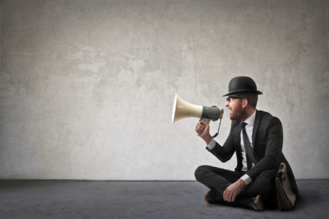 Vintage looking man shouting with a megaphone